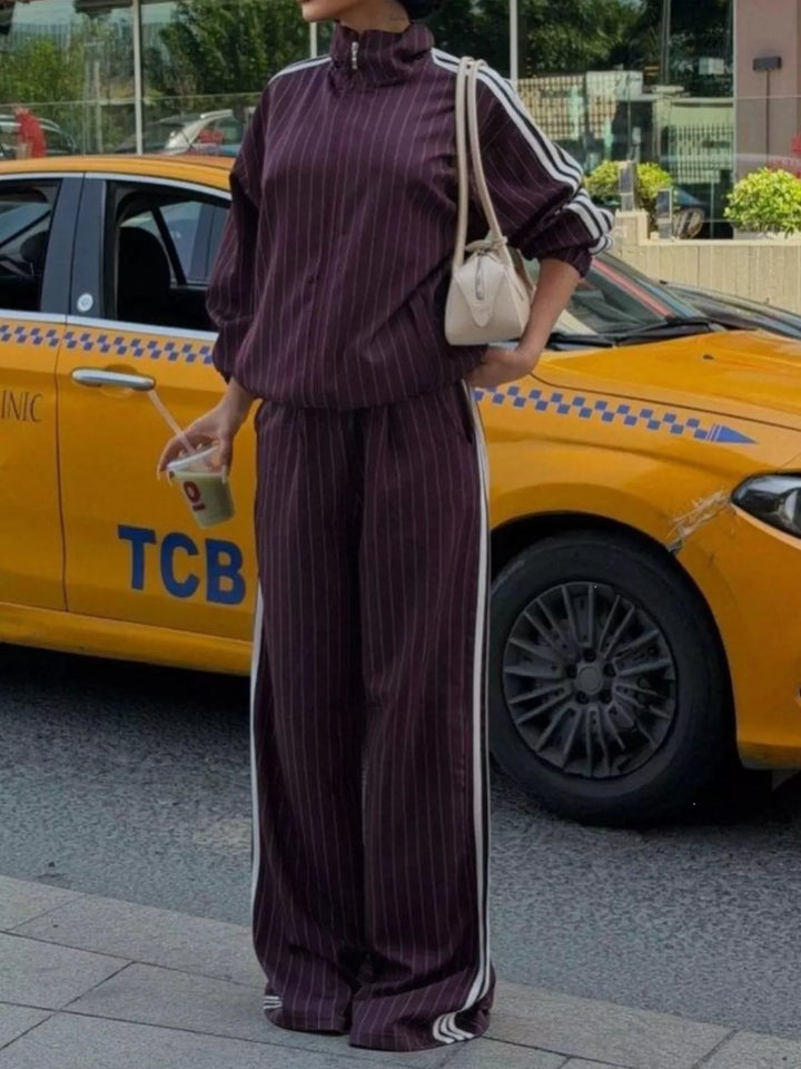 Burgundy pinstripe tracksuit set with zip jacket and wide leg pants, street view