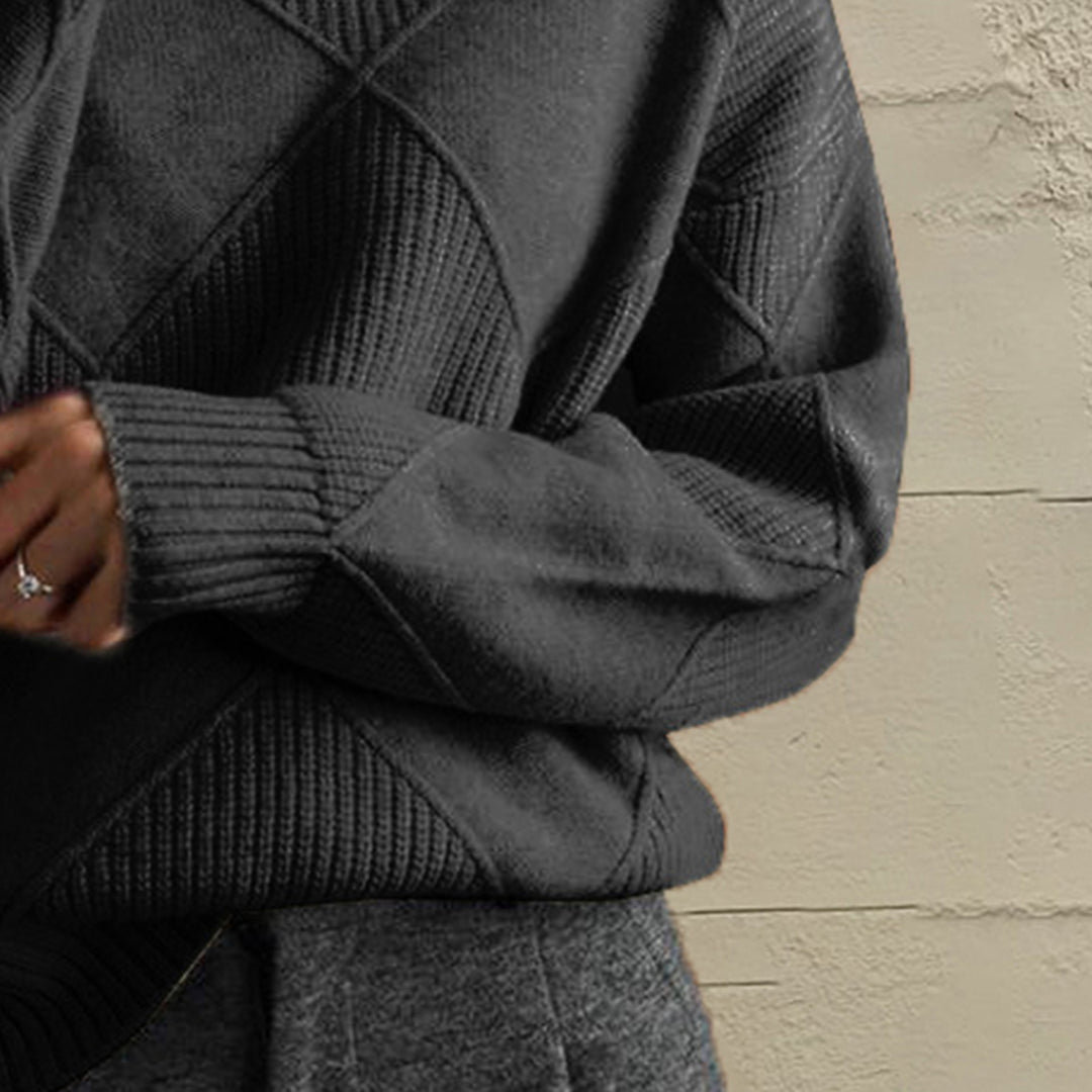 Close-up of the charcoal geometric diamond knit sleeve and ribbed cuff