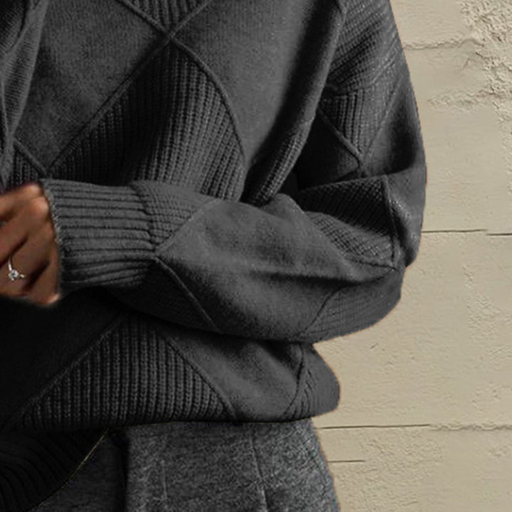 Close-up of the charcoal geometric diamond knit sleeve and ribbed cuff