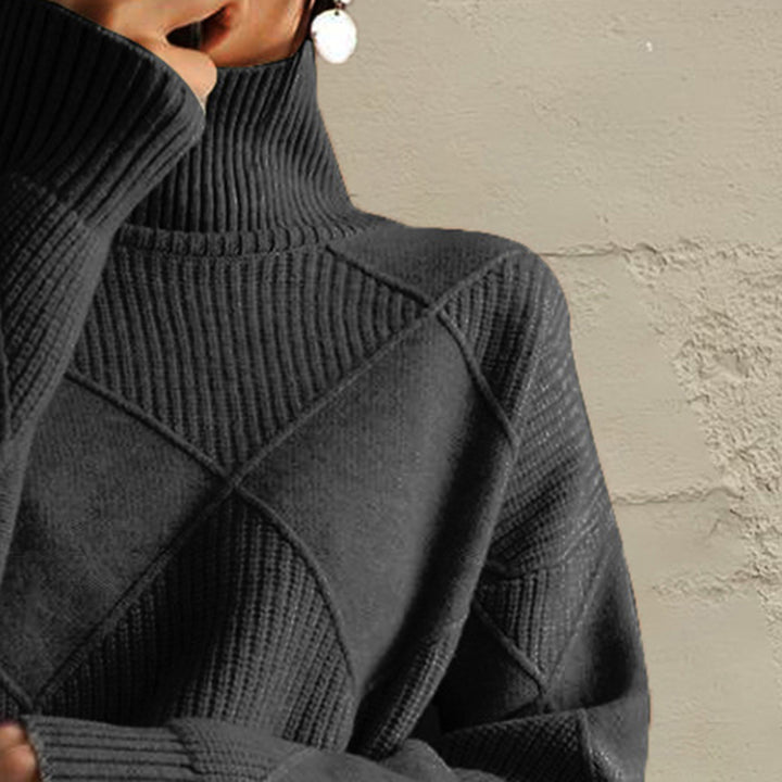 Close-up of the charcoal turtleneck collar and diamond knit pattern