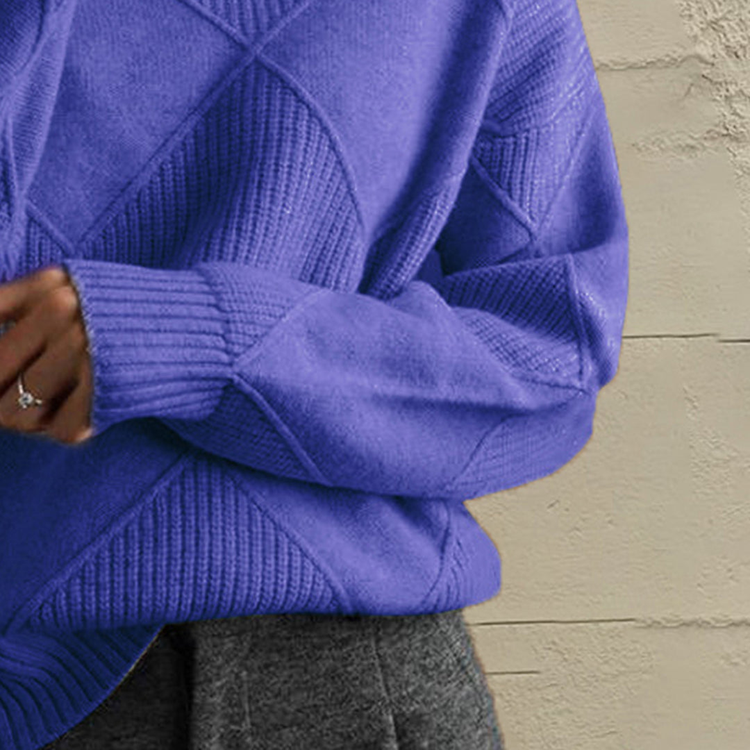 Close-up of the cobalt blue geometric diamond knit sleeve and ribbed cuff