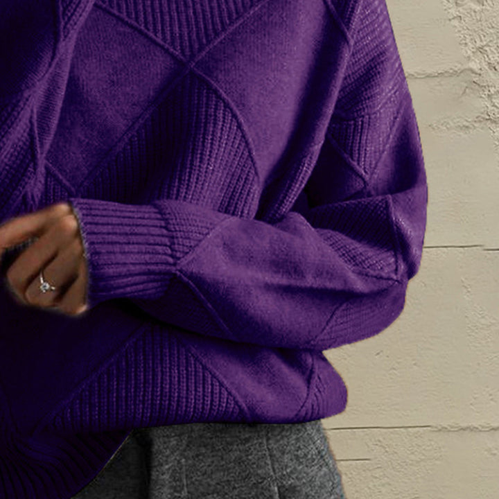 Close-up of the deep purple geometric diamond knit sleeve and ribbed cuff