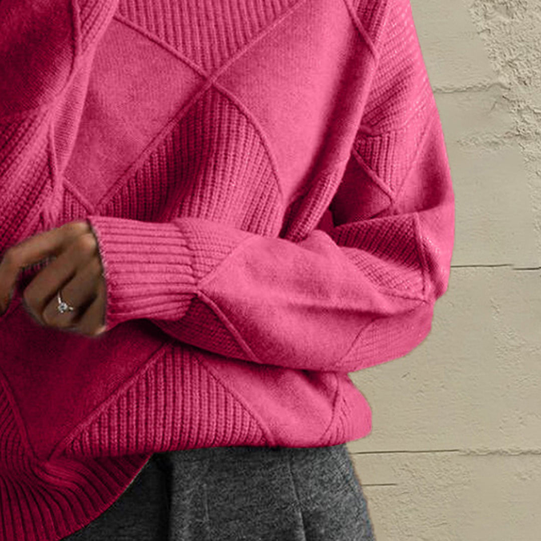 Close-up of the hot pink geometric diamond knit sleeve and ribbed cuff