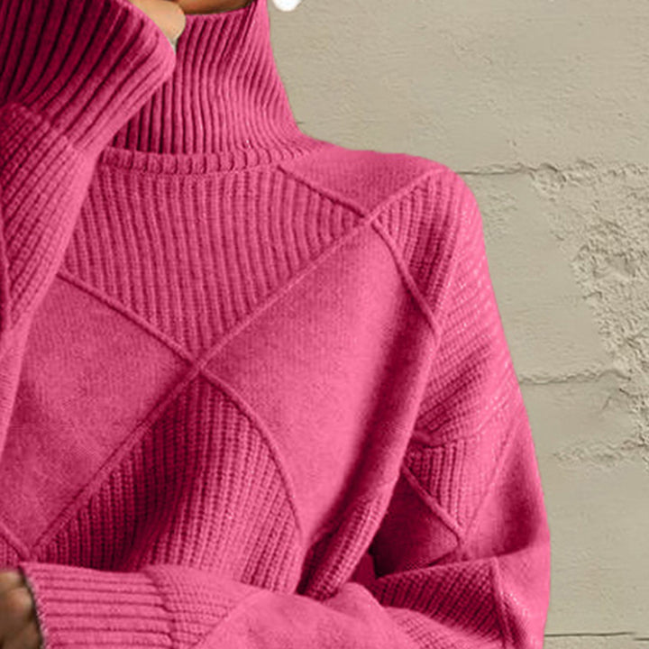 Close-up of the hot pink turtleneck collar and diamond knit pattern