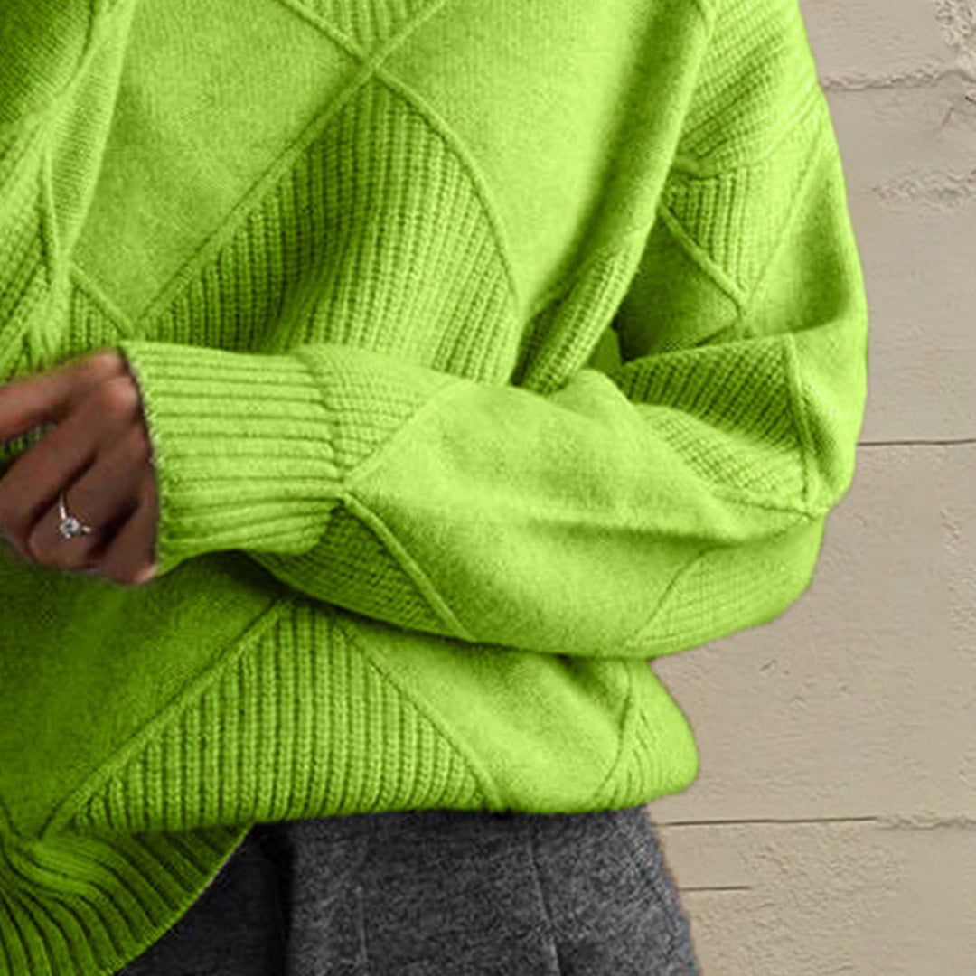 Close-up of the lime green geometric diamond knit sleeve and ribbed cuff