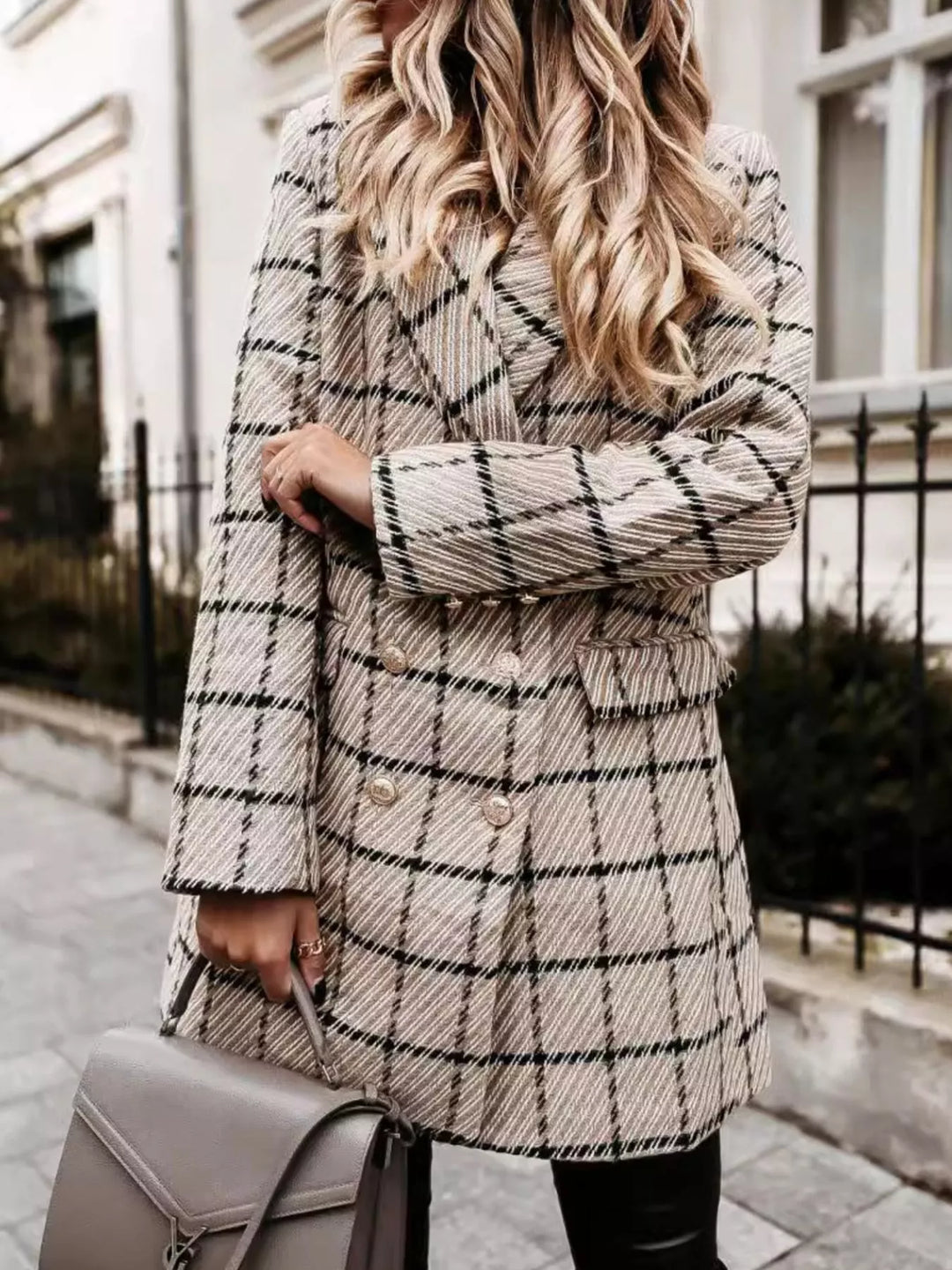 Beige plaid longline blazer in a side turn with hand at the sleeve