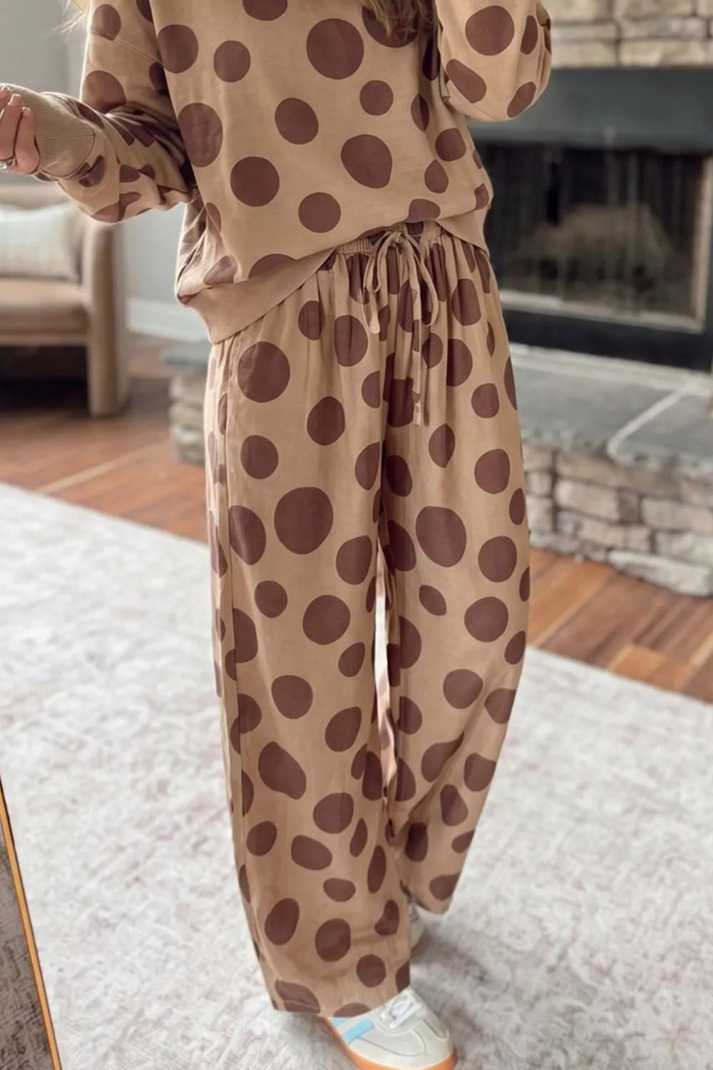 Tan polka dot lounge set styled in a living room, pants and sweatshirt view