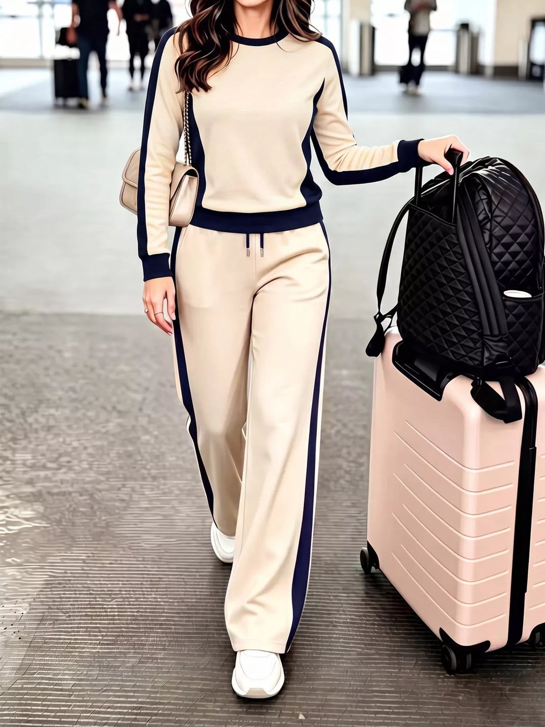 Women's two piece set in beige, crew neck top with contrast side stripes, at the airport