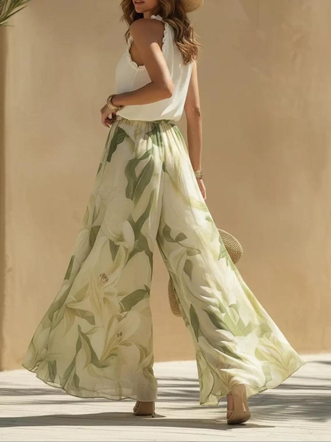 Leaf print wide leg pants flowing in motion with a ruffled halter top