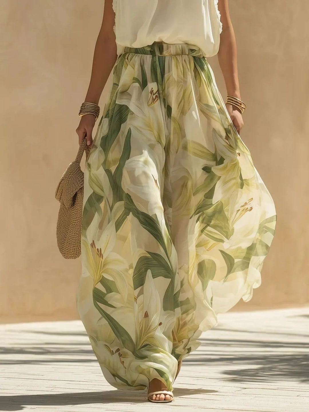 Side angle of the sage floral wide leg pants with a straw bag