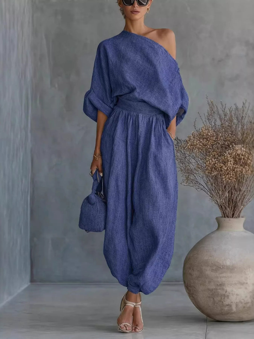 Women's two piece set in blue, one shoulder top and balloon pants, full length