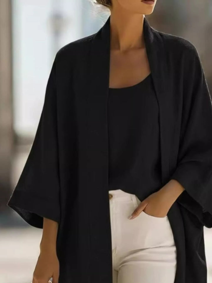 Close-up of the black open front kimono cardigan over a black tank