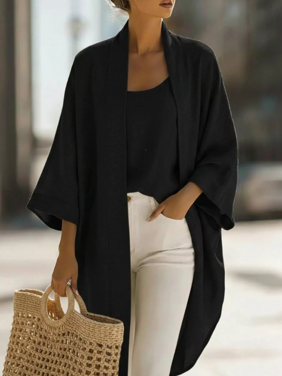 Black kimono cardigan and tank set worn with white pants and a woven bag