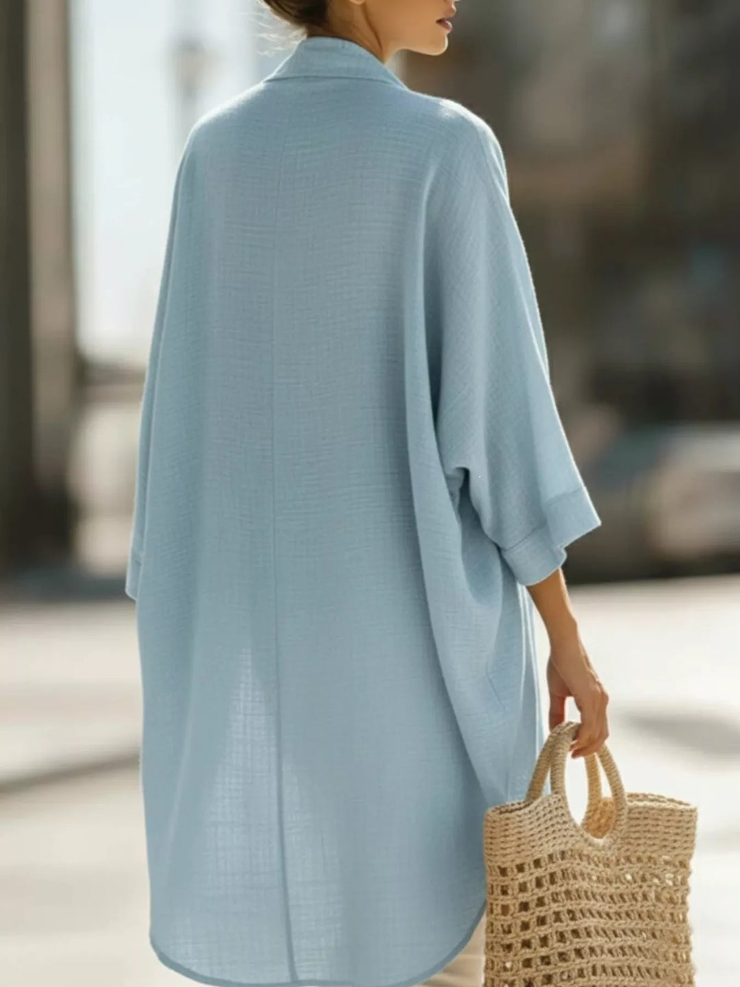 Back view of the sky blue kimono cardigan showing the curved hem
