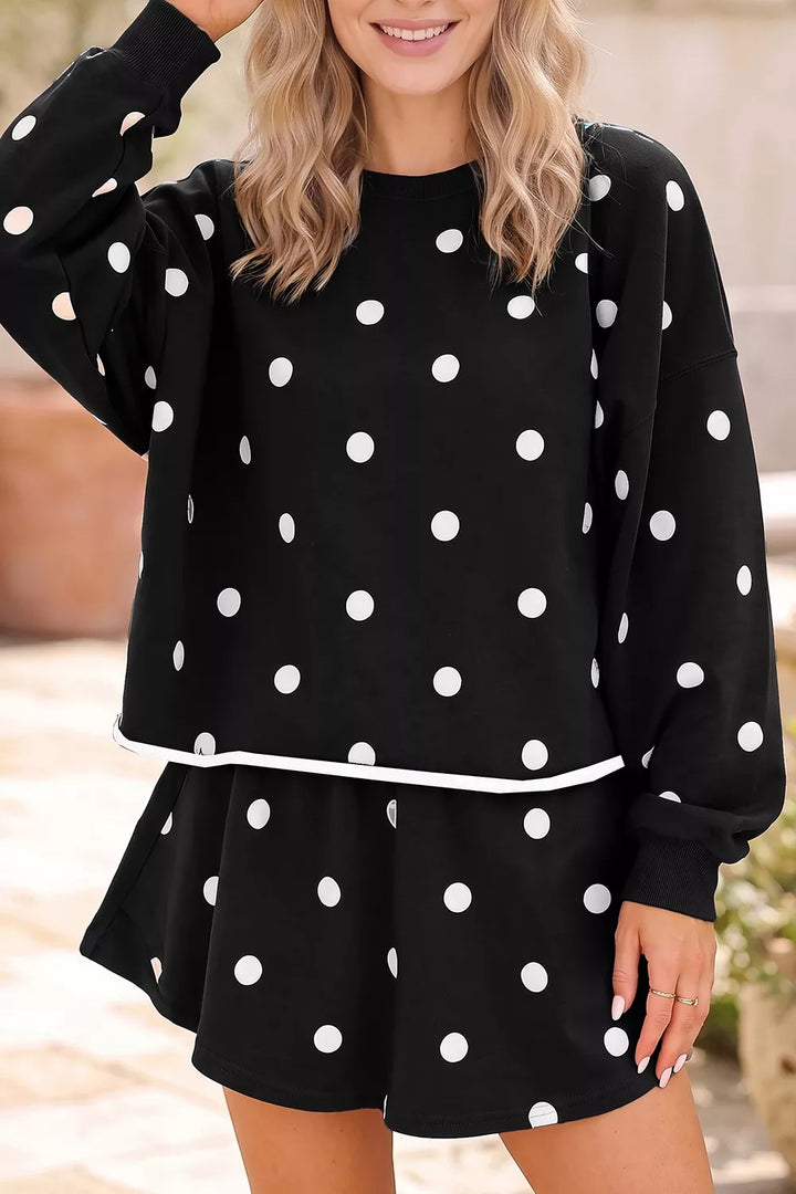 Women's two piece set in black, polka dot sweatshirt with ruffle skort, front view