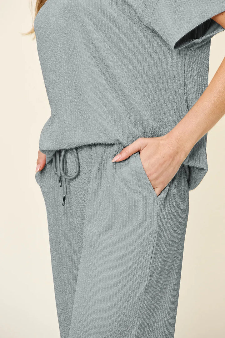 Close-up of the dusty blue drawstring waist and pocket
