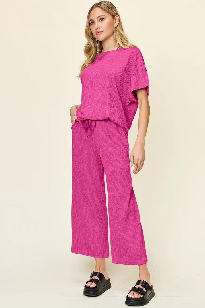 Hot pink two piece set with short sleeve top and cropped pants