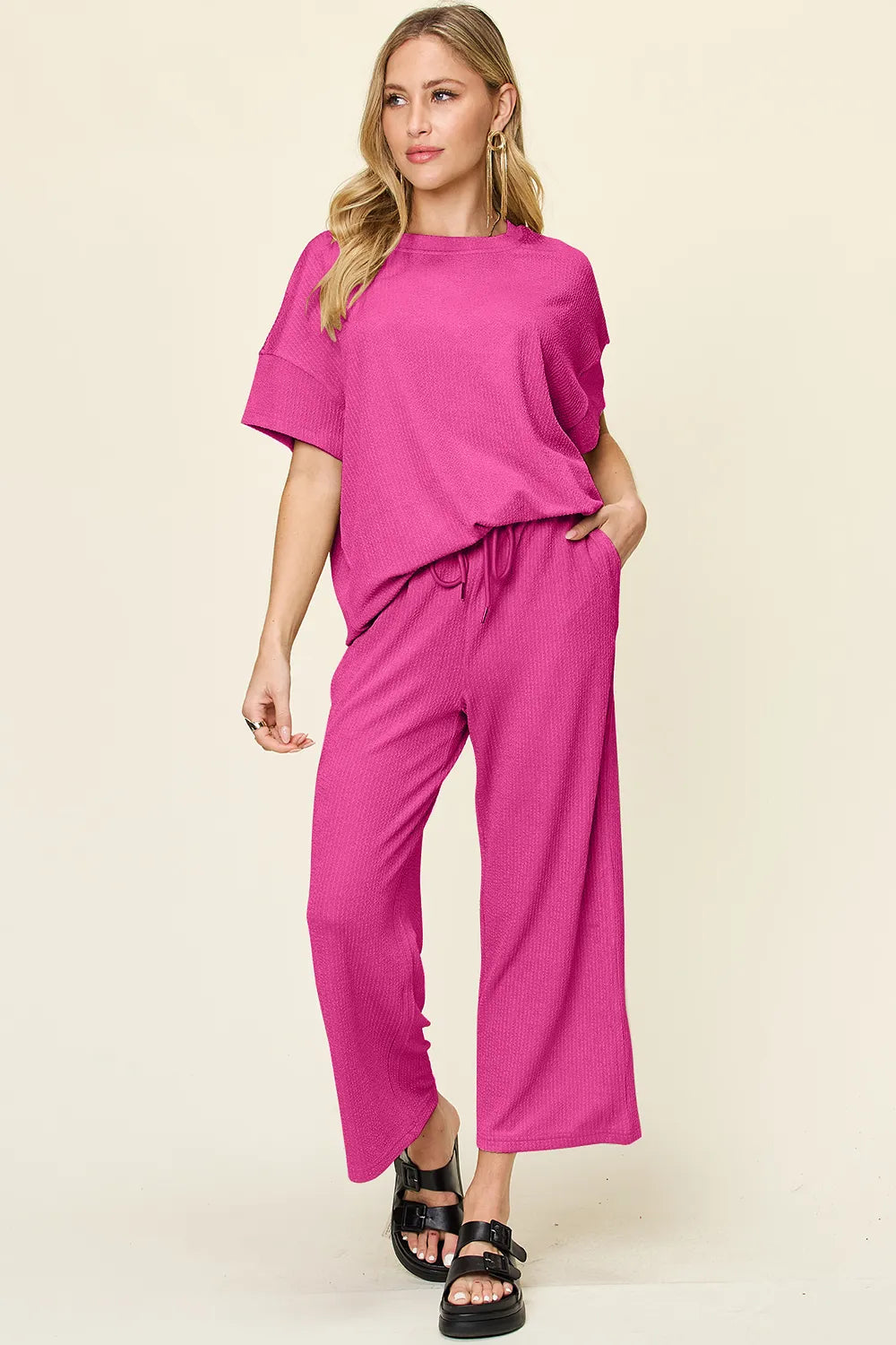 Hot pink two piece set styled with black platform sandals, hand raised
