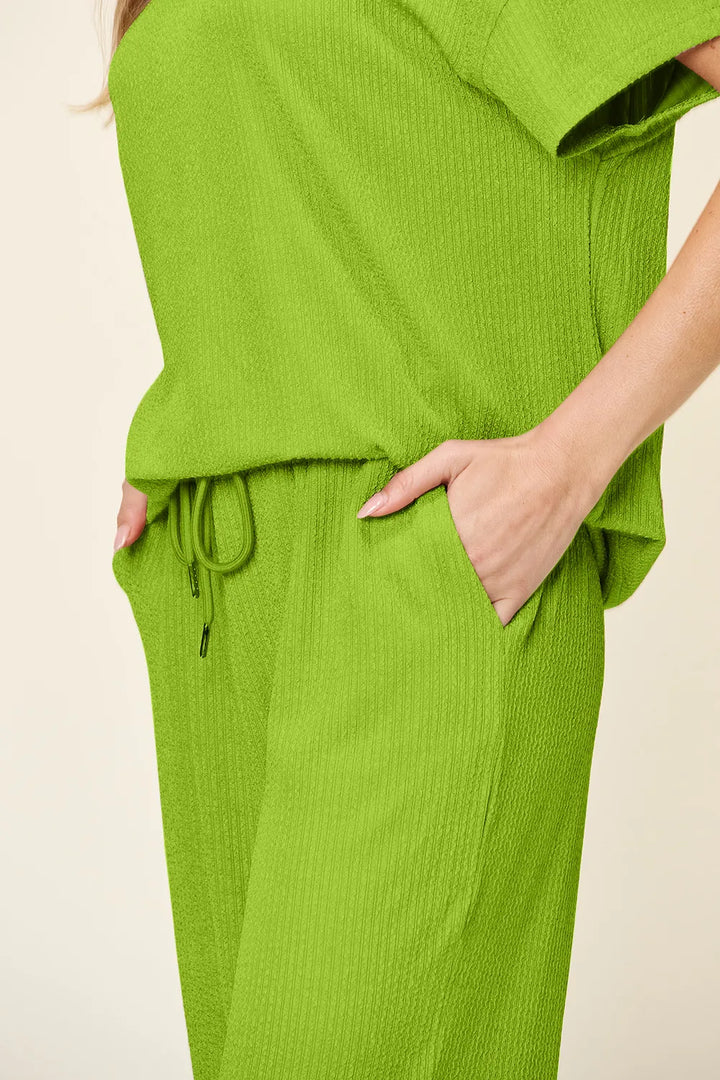 Close-up of the lime green drawstring waist and side pocket