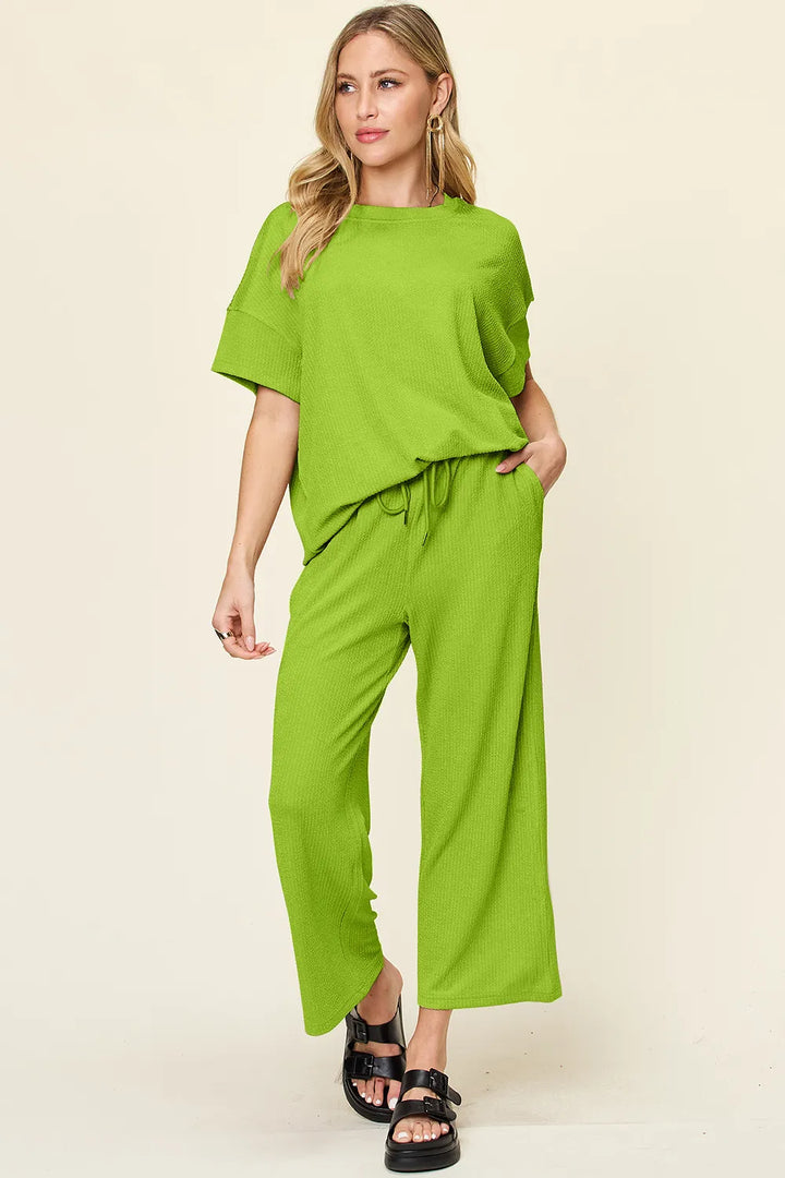 Women's two piece set in lime green with short sleeve top and cropped pants