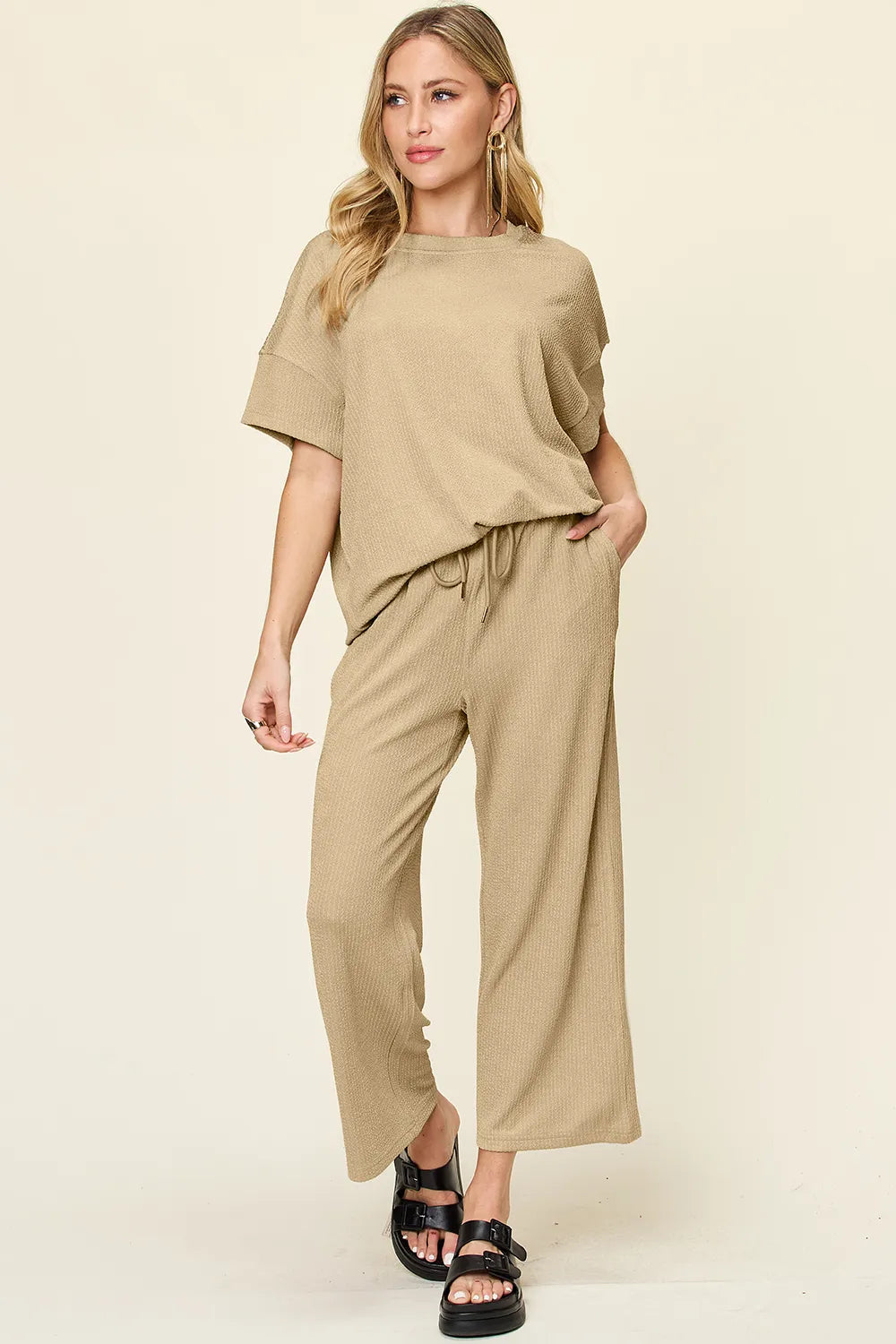 Tan two piece set with short sleeve top and cropped pants