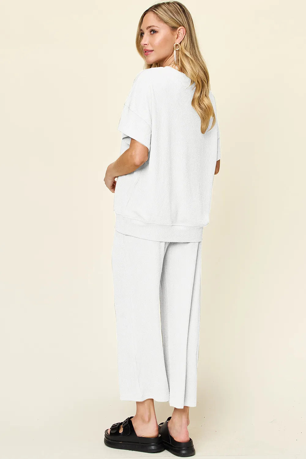 Back view of the white two piece set, looking over the shoulder