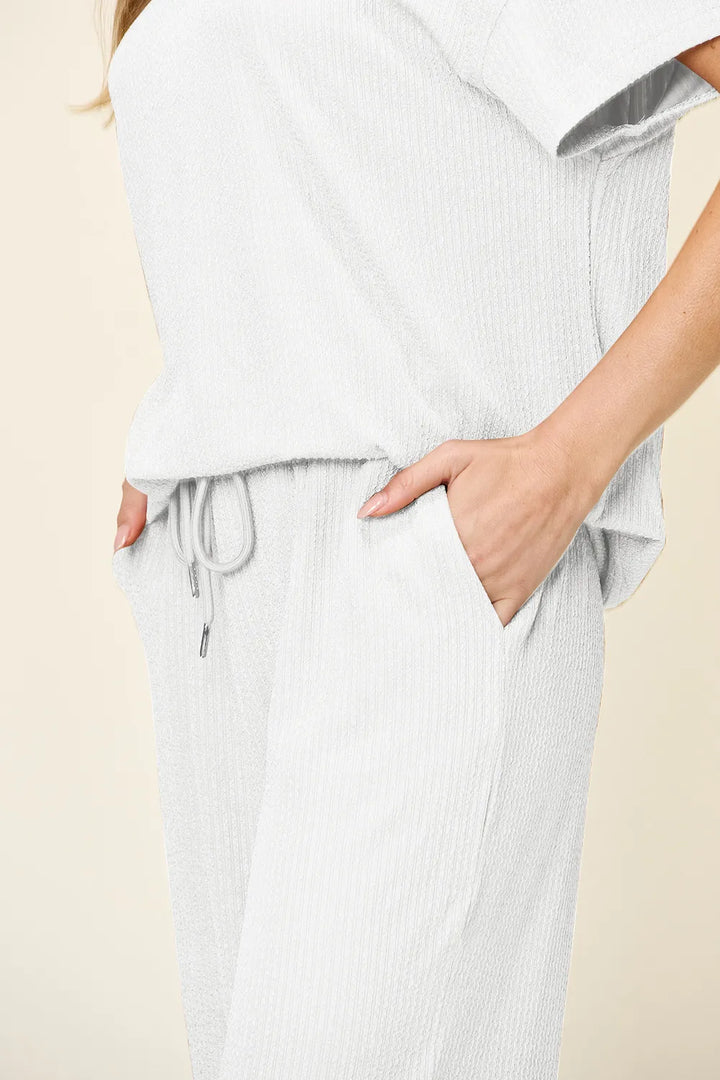 Close-up of the white drawstring waist and hand in pocket