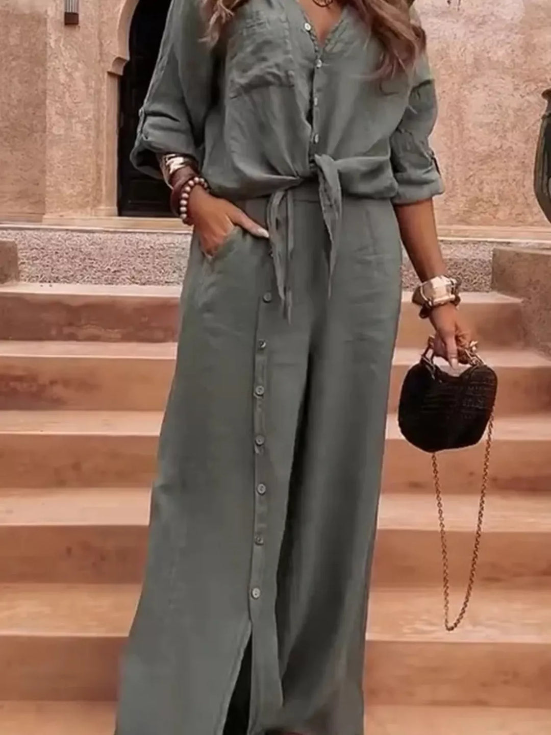 Sage green tie front shirt and wide leg pants, hand in pocket, button placket visible