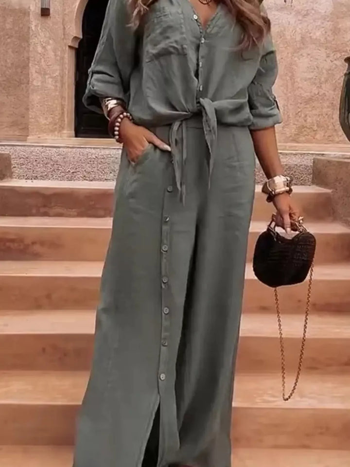 Sage green tie front shirt and wide leg pants, hand in pocket, button placket visible