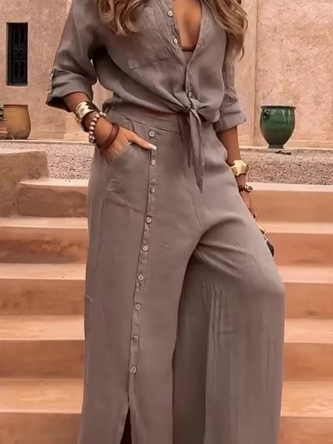 Taupe tie front shirt and wide leg pants, hand in pocket, close three quarter view