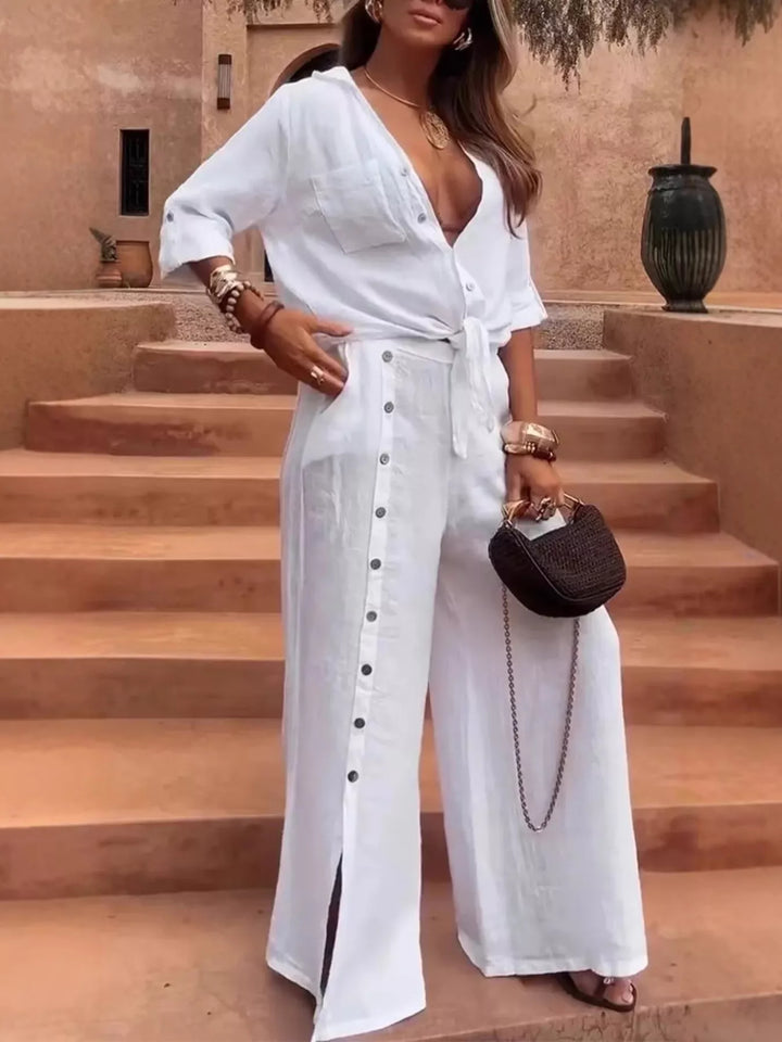White two piece set with plunging tie front shirt and wide leg pants with side slit
