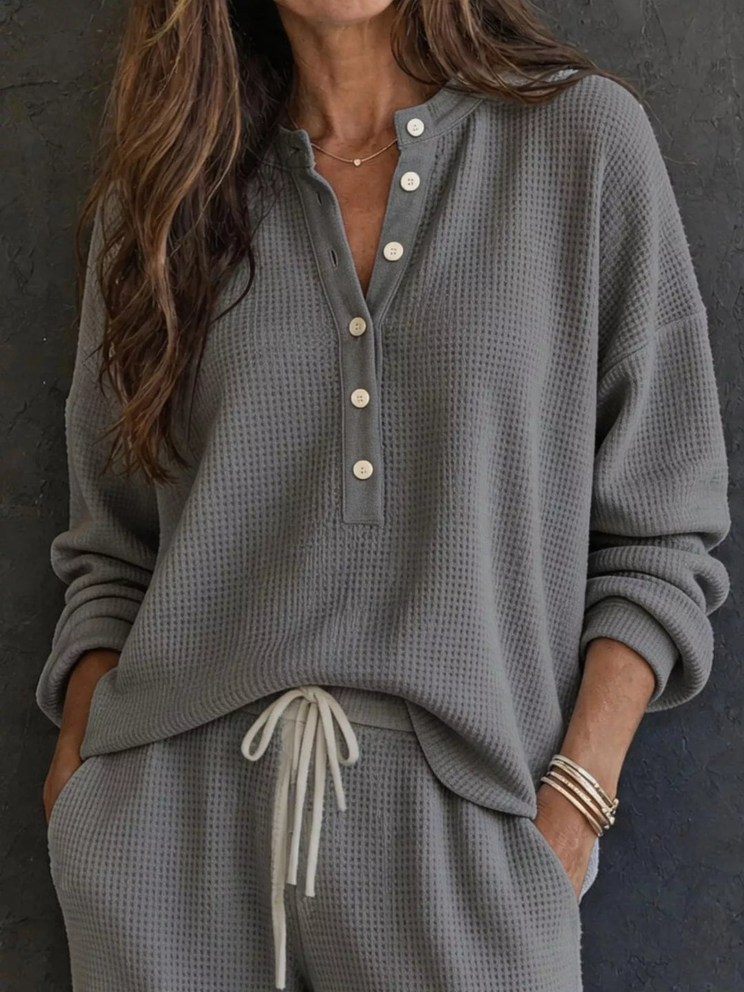 Charcoal waffle knit henley top with button placket and drawstring pants, close-up
