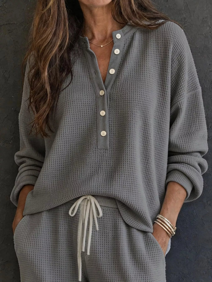 Charcoal waffle knit henley top with button placket and drawstring pants, close-up