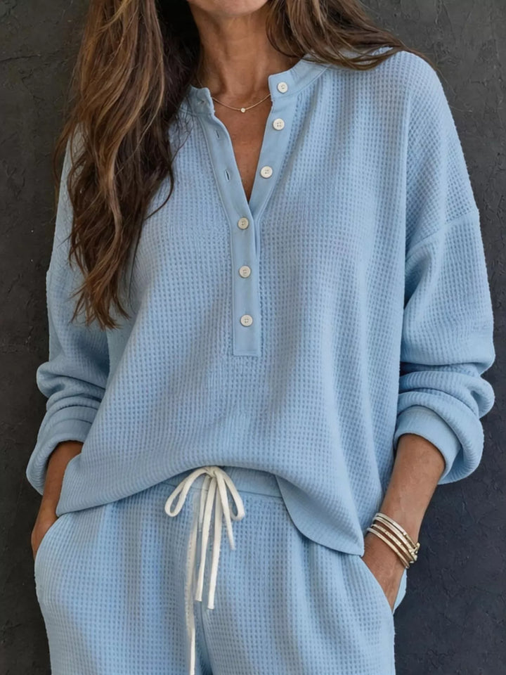 Light blue waffle knit henley top with button placket and drawstring pants, close-up