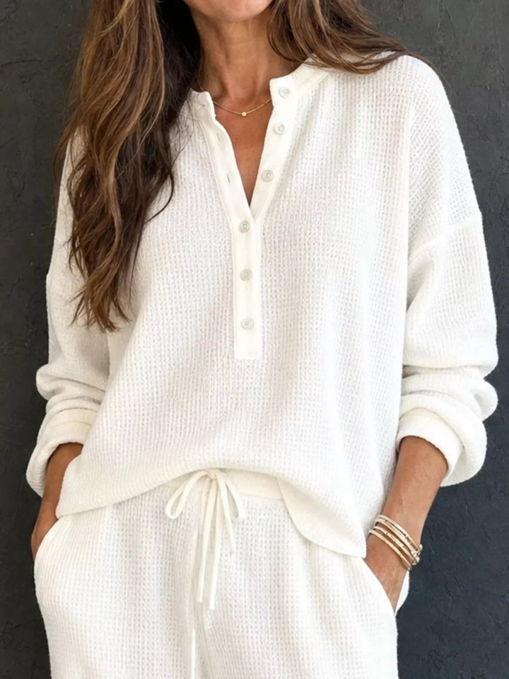 White waffle knit henley top with button placket and drawstring pants, close-up