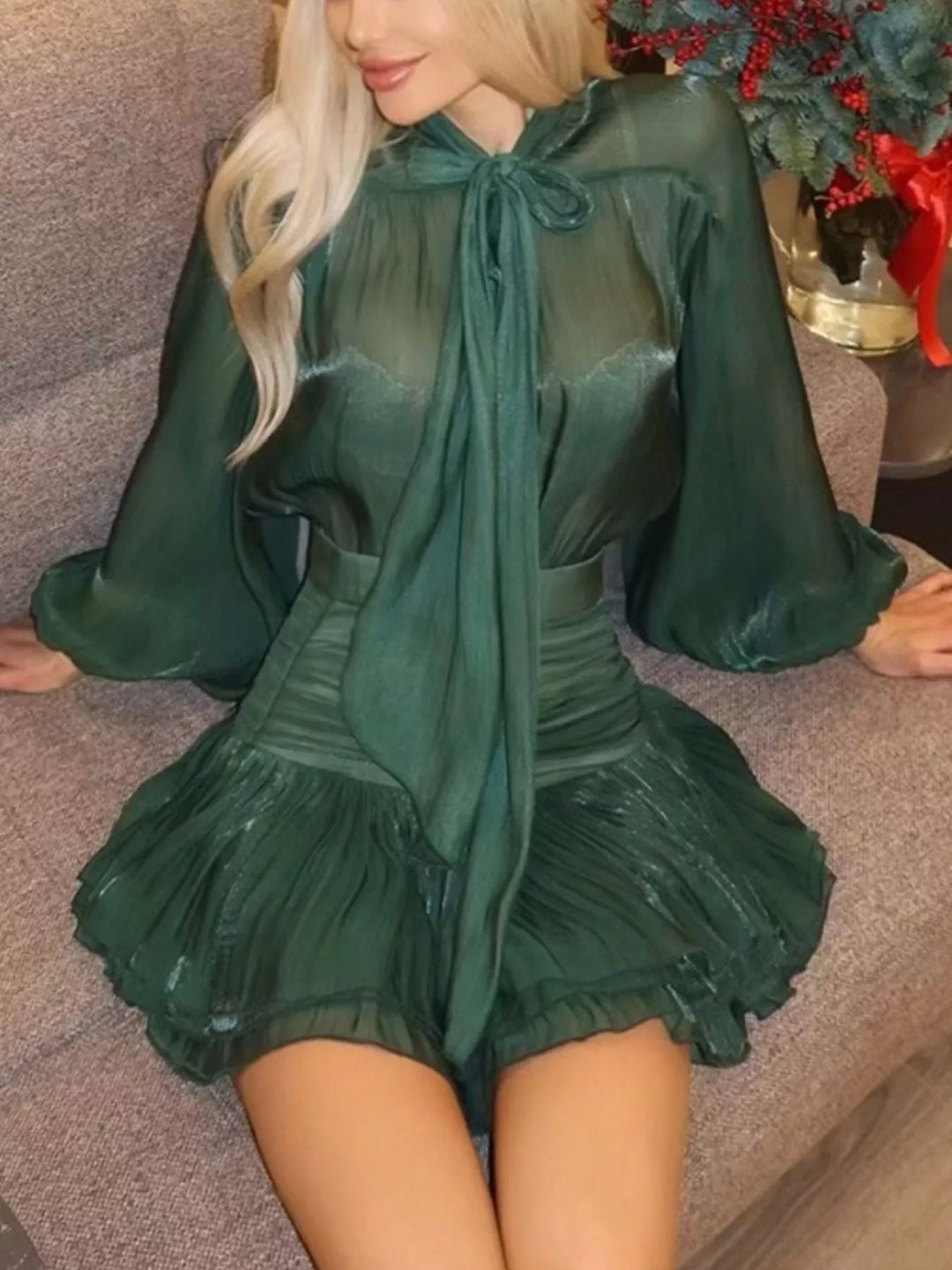 Front view of the emerald sheer sleeve blouse with long bow tie and mini skirt