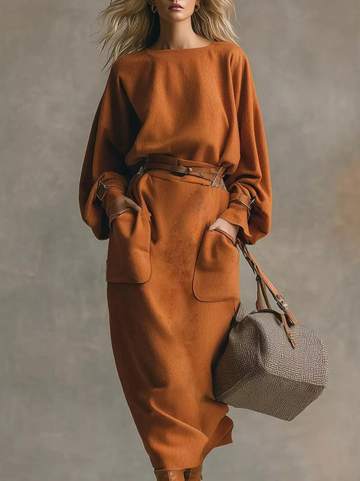 Women's two piece skirt set in rust, oversized top with belted midi skirt and gray bag