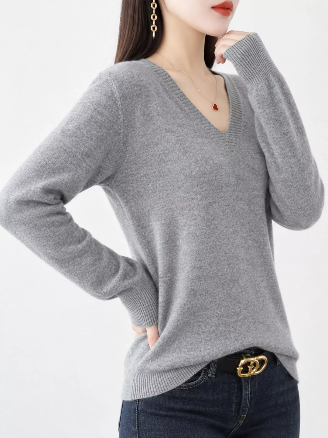 Gray V neck sweater worn on-model, side angle with a relaxed fit