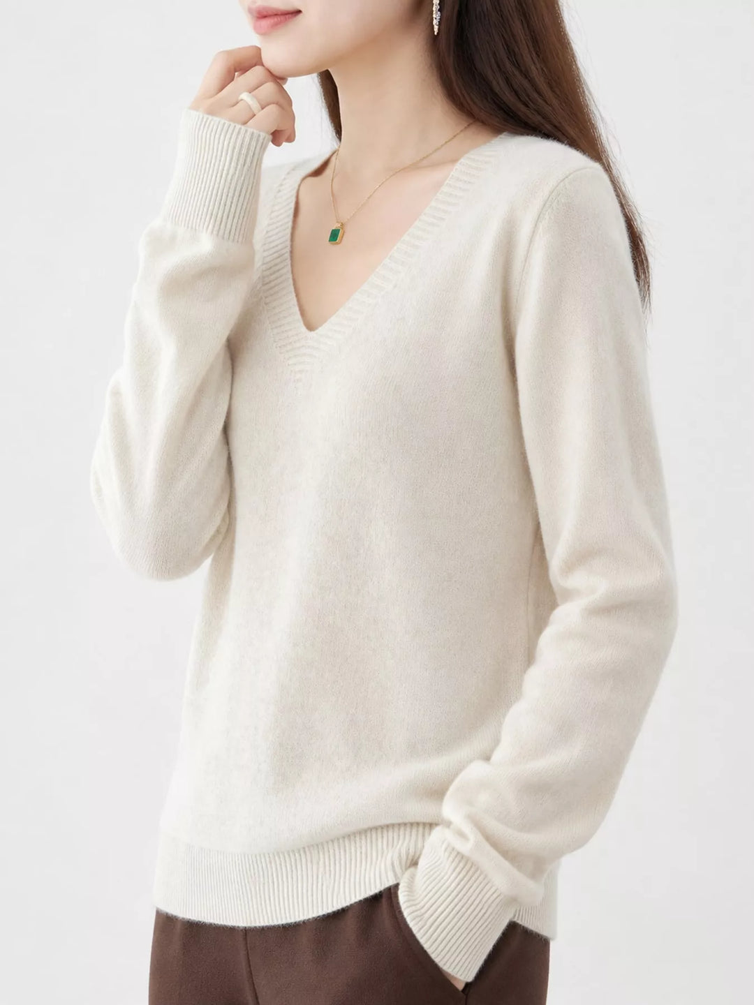 Light Beige V neck sweater worn on-model, side angle with a relaxed fit