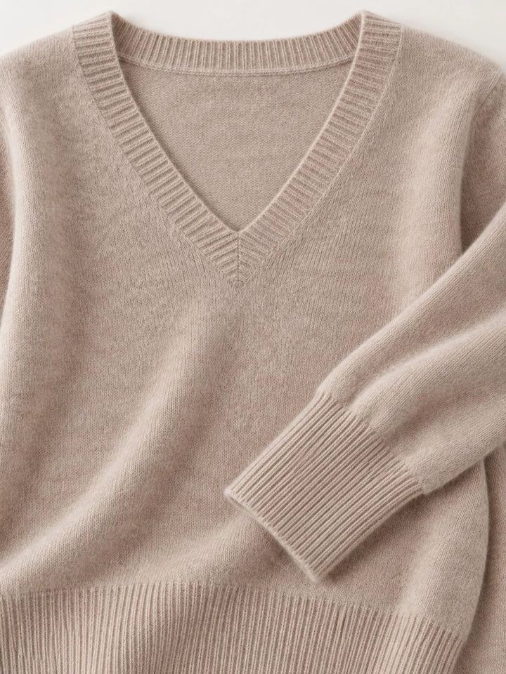 Close-up details of the light camel sweater neckline, ribbed cuff and hem