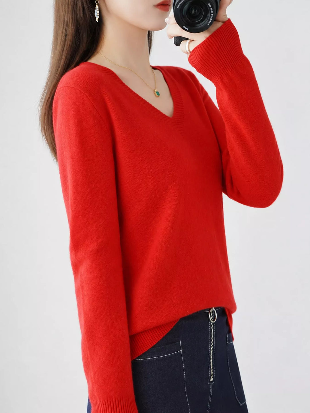 Red V neck sweater worn on-model, side angle with a relaxed fit