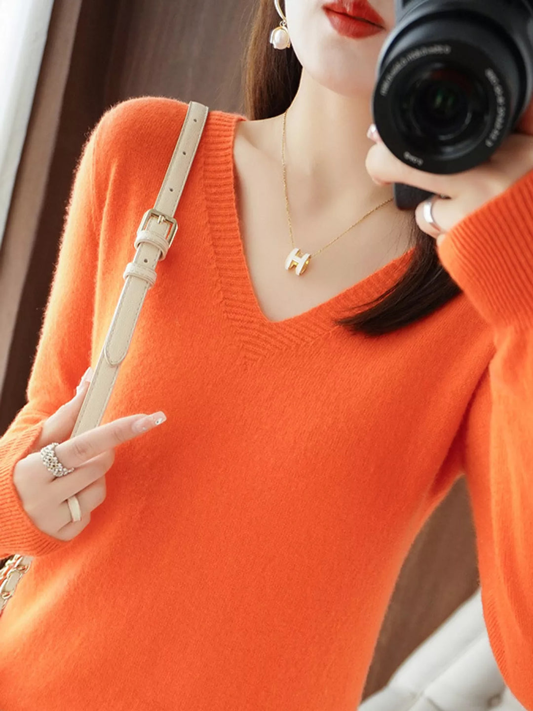 V neck sweater in vibrant orange, on-model front view with long sleeves