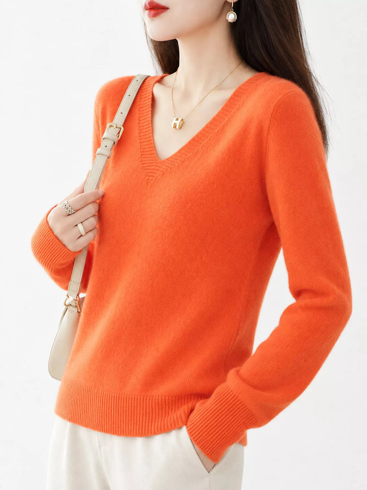 Vibrant Orange V neck sweater worn on-model, side angle with a relaxed fit