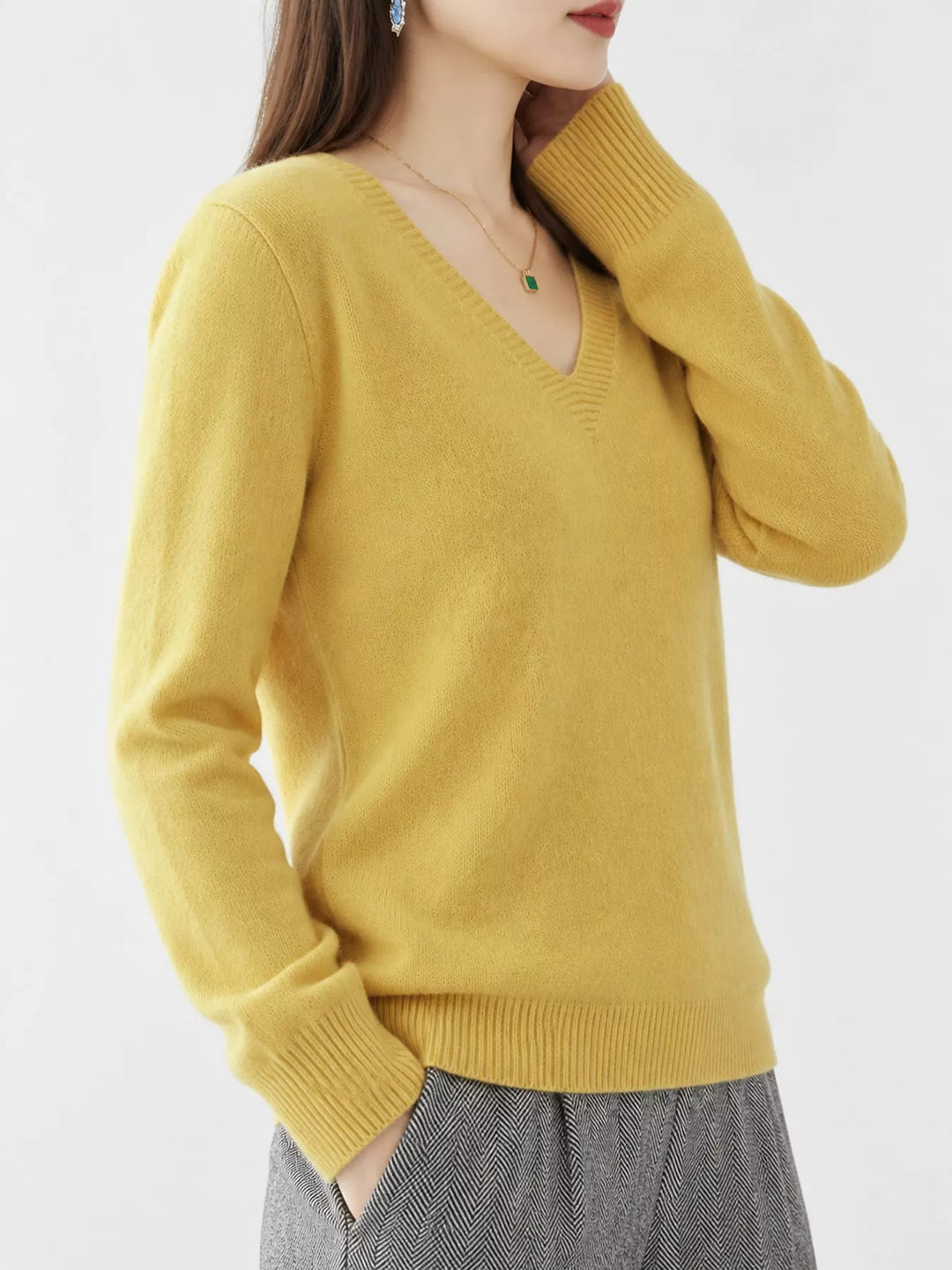 Yellow V neck sweater worn on-model, side angle with a relaxed fit