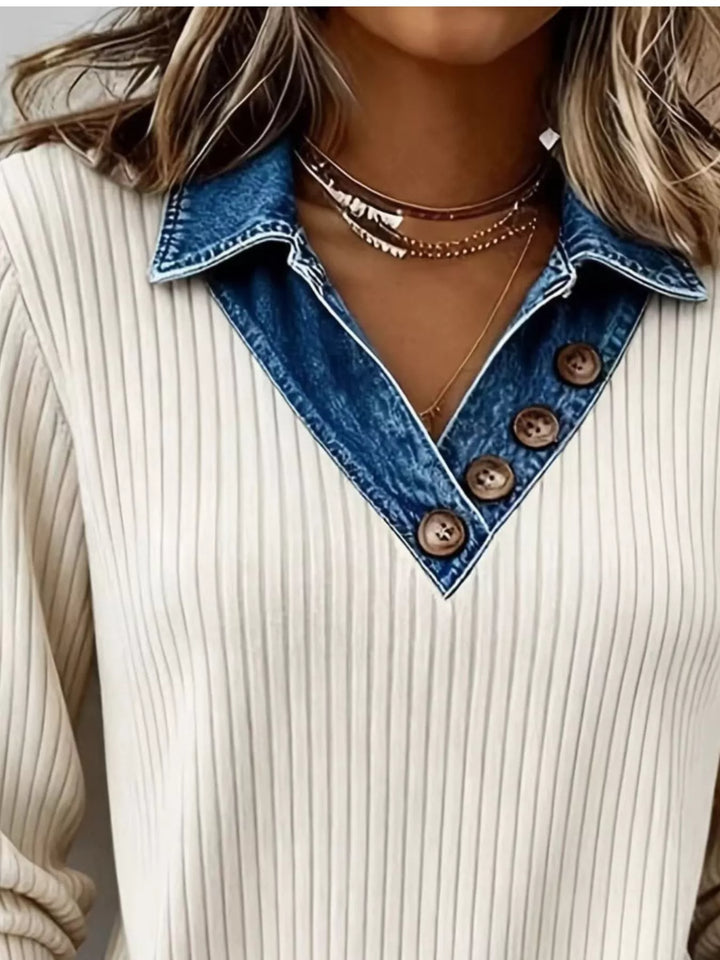 Close-up of the layered collar with buttons on the cream ribbed knit sweater