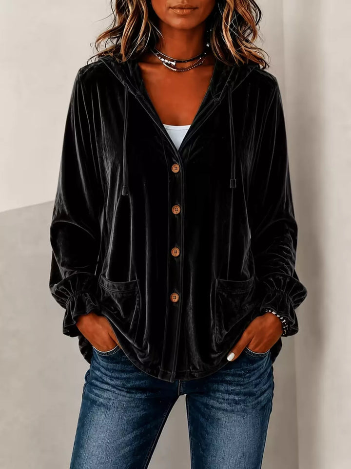 Black velvet jacket with hood and button front, styled over a white top and denim