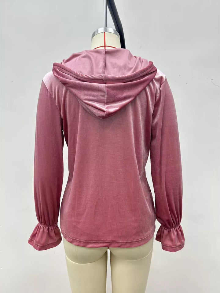 Back view of the dusty pink velvet jacket with hood and ruffled cuffs