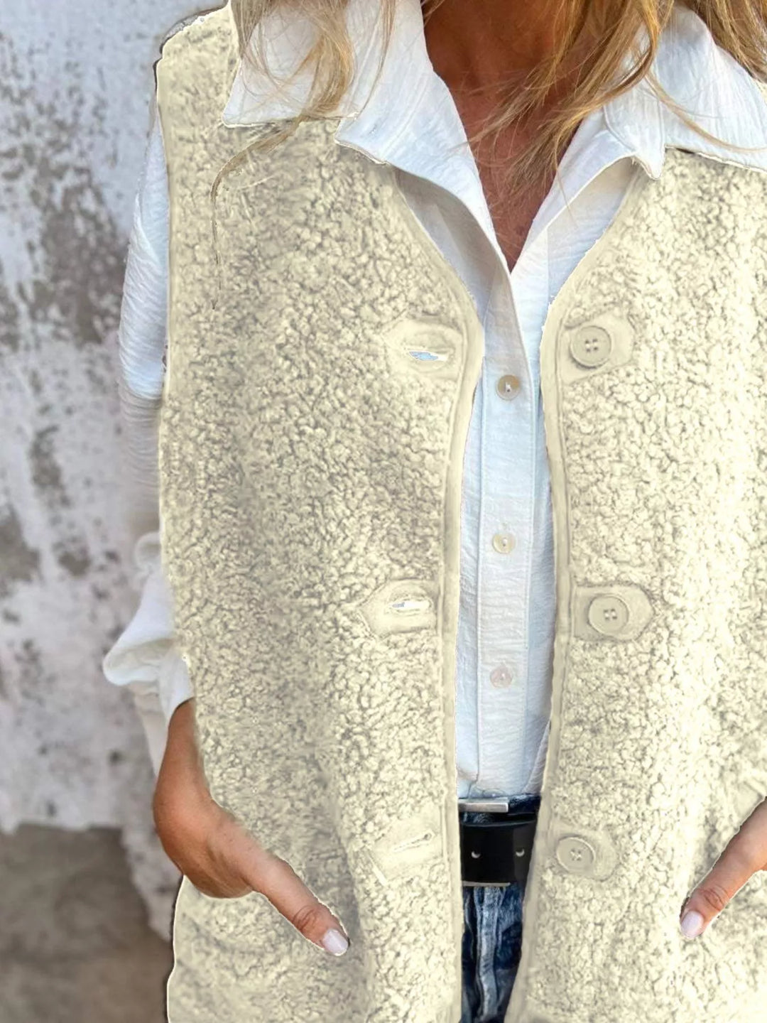 Front view of the cream button front vest with hands in the pockets