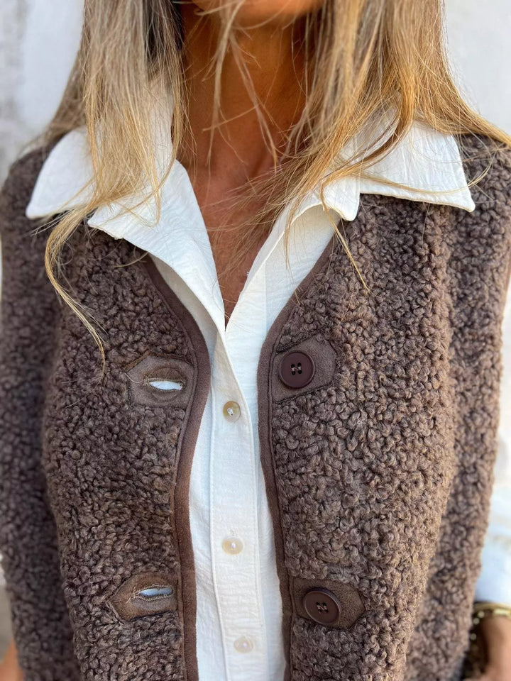 Close-up of the mocha fluffy vest buttons and textured front