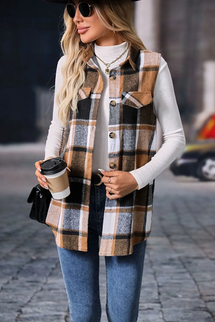 Camel plaid sleeveless vest worn with sunglasses and a coffee cup